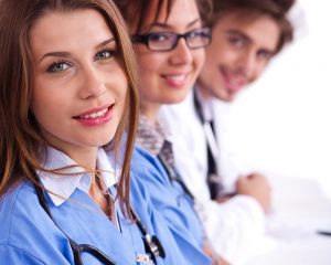 Doctors in hospital gowns in row