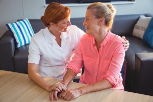 Nurse taking care of a senior woman in a retirement home